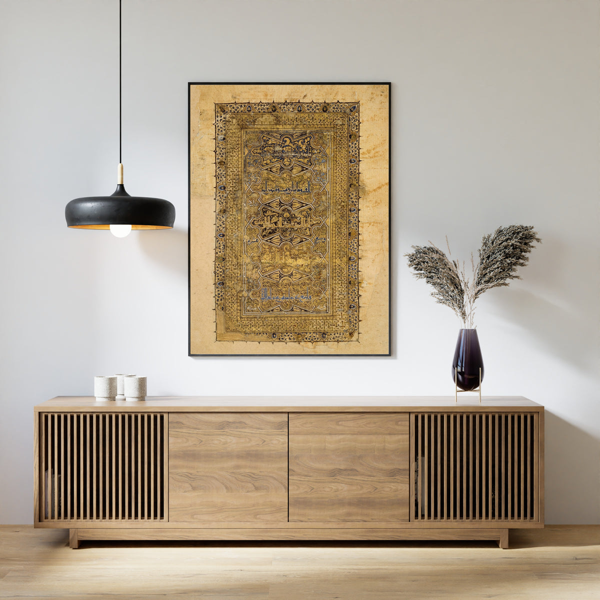 Framed art print of Folio from a Qur'an Manuscript by Muhammad al-Zanjani, above a slatted wood sideboard