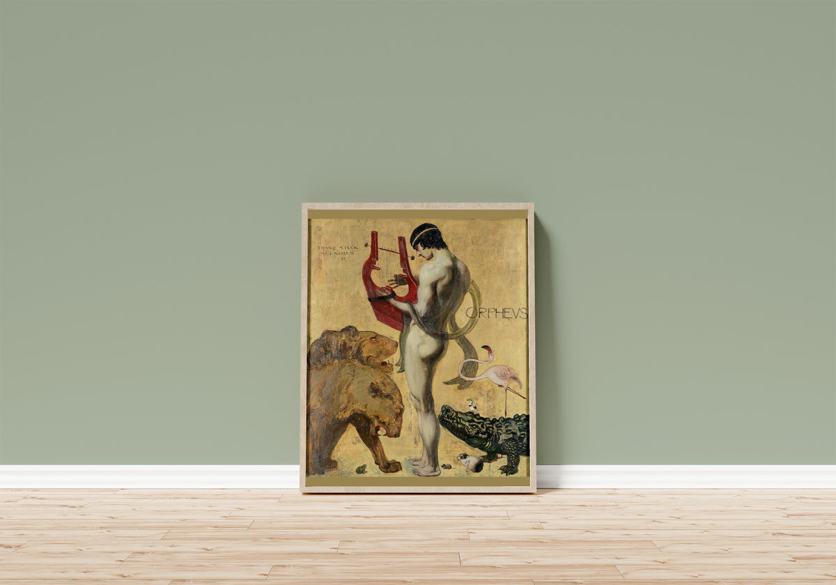 Framed art print of Orpheus by Franz von Stuck, in a light wood frame leaning on a sage green wall above a wooden floor