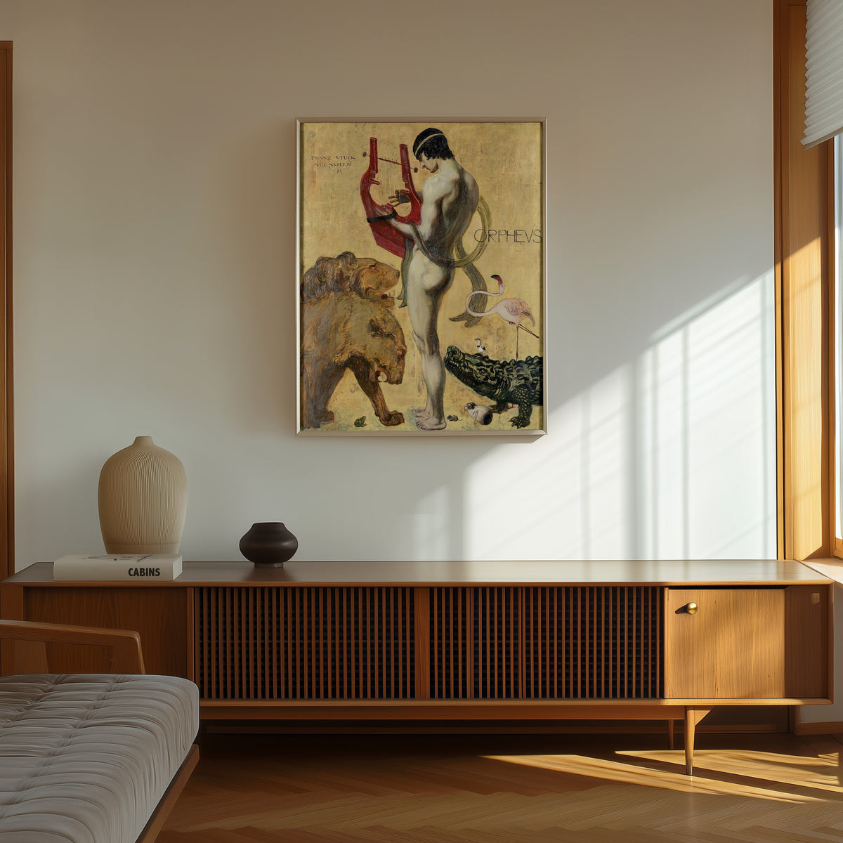 Framed art print of Orpheus by Franz von Stuck, in a thin light frame on a sunlit wall above a wooden sideboard