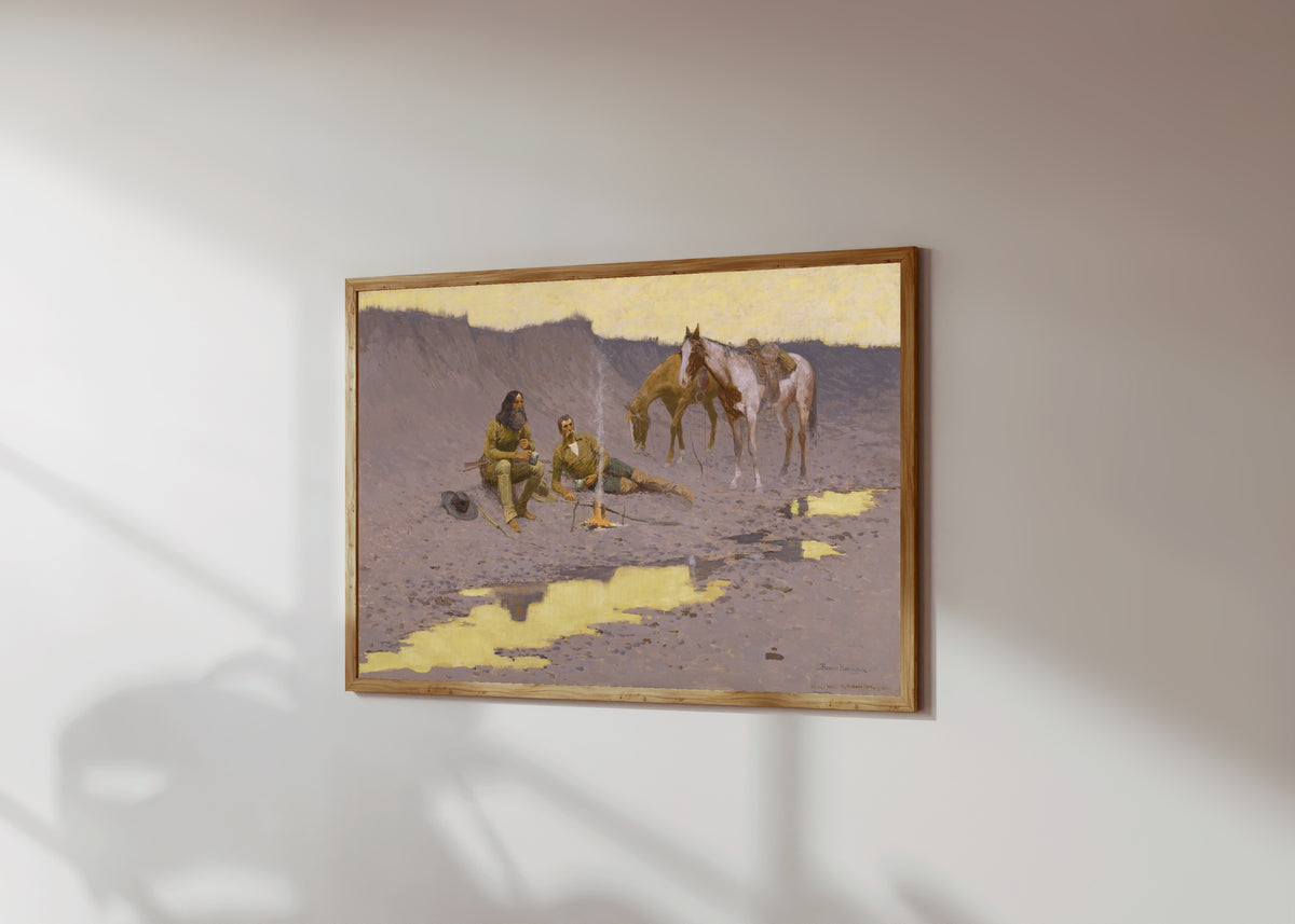 Framed art print of A New Year on the Cimarron by Frederic Remington, in a light wood frame on a sunlit white wall, seen at a slight angle