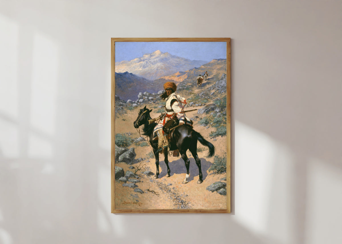 Framed art print of An Indian Trapper by Frederic Remington, in a light wood frame on a sunlit white wall