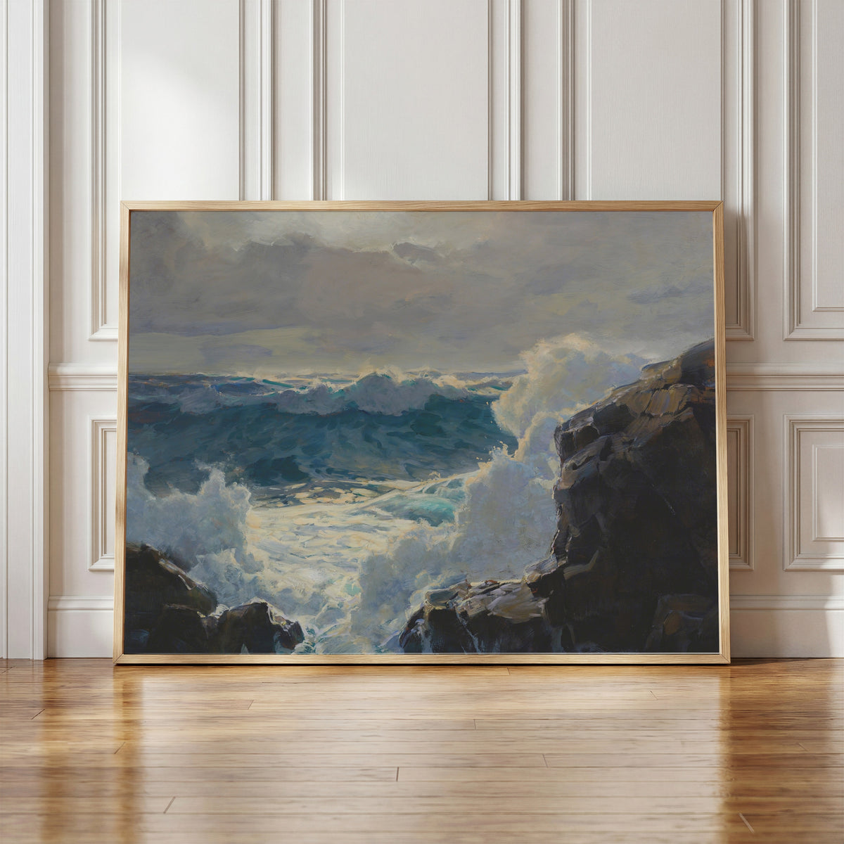 Framed art print of Breaking Waves by Frederick Judd Waugh, in a light wood frame leaning against a panelled white wall