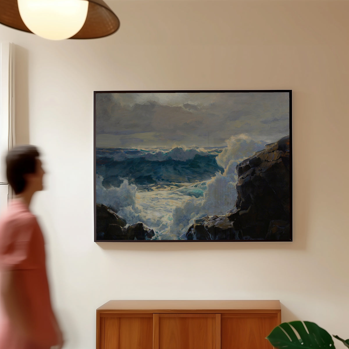 Framed art print of Breaking Waves by Frederick Judd Waugh, in a slim black frame on a warm wall in a sunlit room