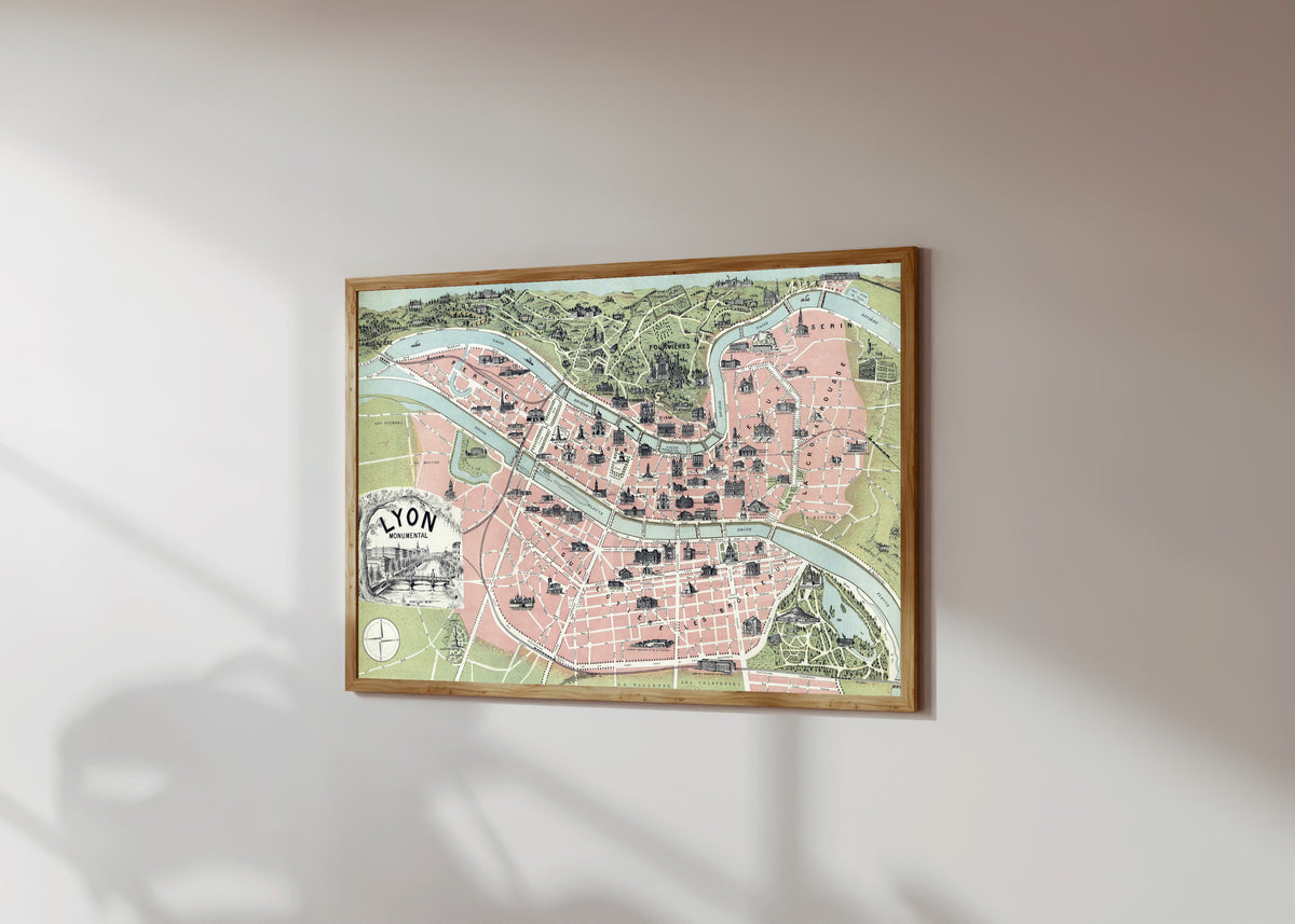 Framed art print of Lyon Monumental by Garnier Frères, in a light wood frame on a sunlit white wall, seen at a slight angle