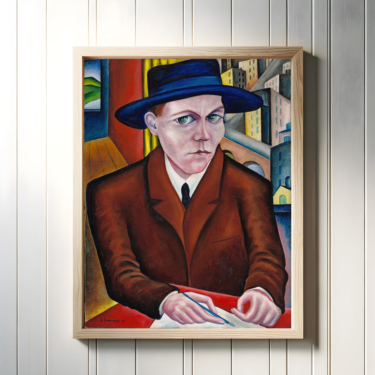Framed art print of Oscar Maria Graf by Georg Schrimpf, in a light wood frame on a white panelled wall