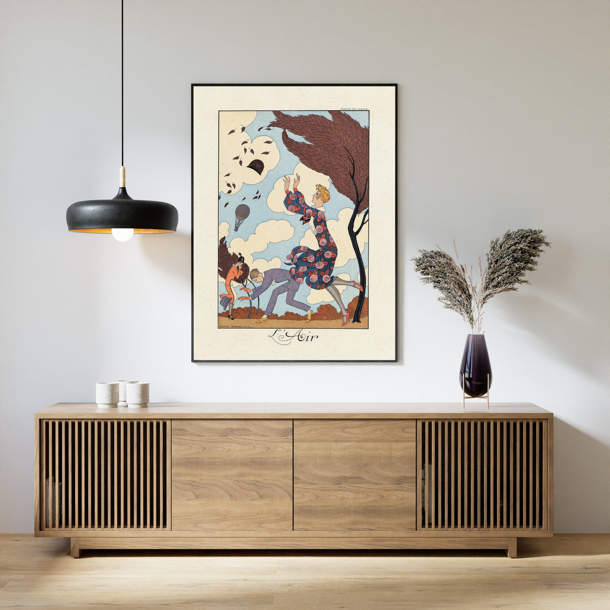 Framed art print of L'Air by George Barbier, above a slatted wood sideboard