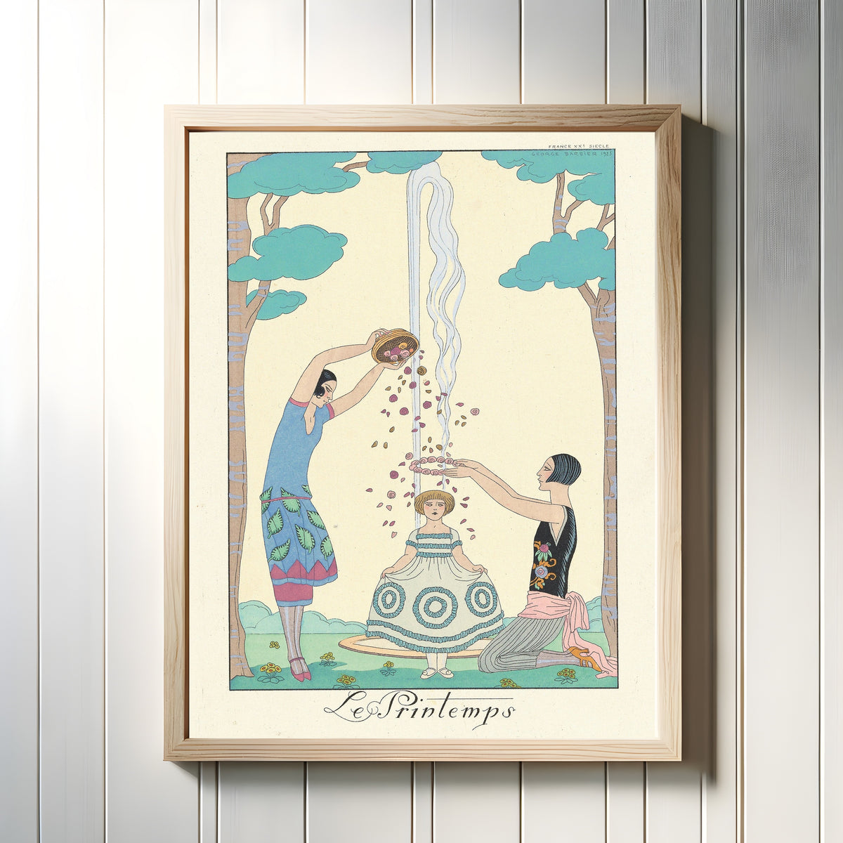 Framed art print of Le Printemps [Spring] by George Barbier, in a light wood frame on a white panelled wall