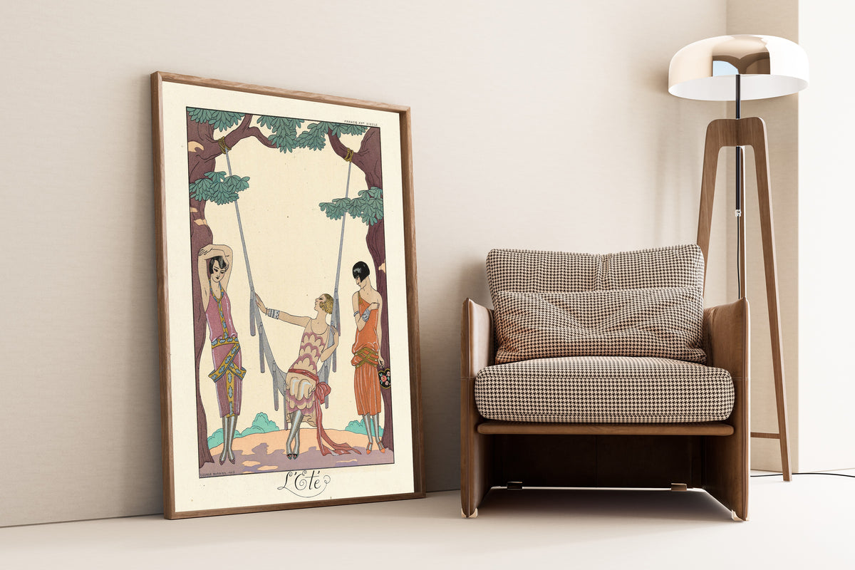 L'Été by George Barbier — framed and leaning against a wall beside an armchair and a floor lamp