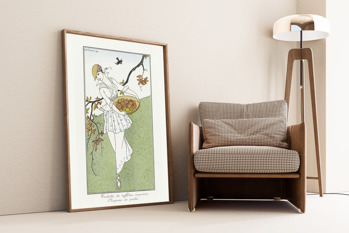 Toilette de taffetas imprimé, Chapeau de paille [Printed taffeta dress, straw hat] by George Barbier — framed and leaning against a wall beside an armchair and