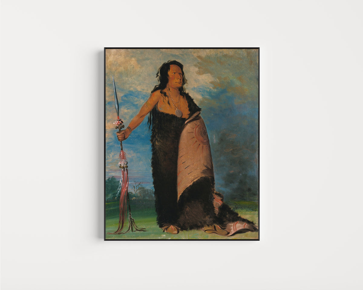 Framed art print of Shoo-de-gá-cha, The Smoke, Chief of the Tribe by George Catlin, in a slim black frame on a plain white wall