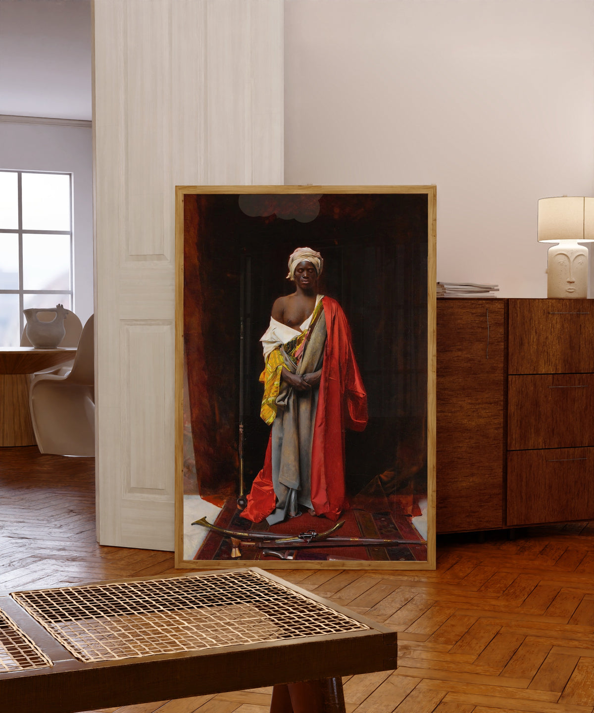 Framed art print of A Consecration of Arms by George Seymour, in a light wood frame leaning in a warm room with a parquet floor