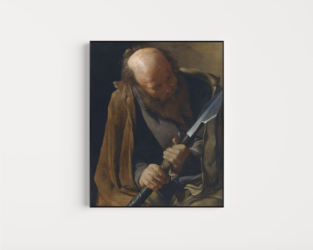 Framed art print of St. Thomas by Georges de La Tour, in a slim black frame on a plain white wall