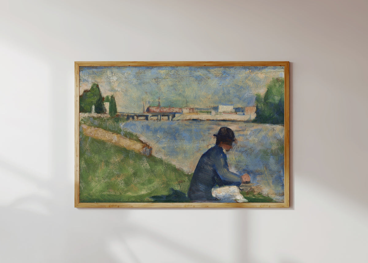 Framed art print of Study for "Bathers at Asnières" by Georges Seurat, in a light wood frame on a sunlit white wall