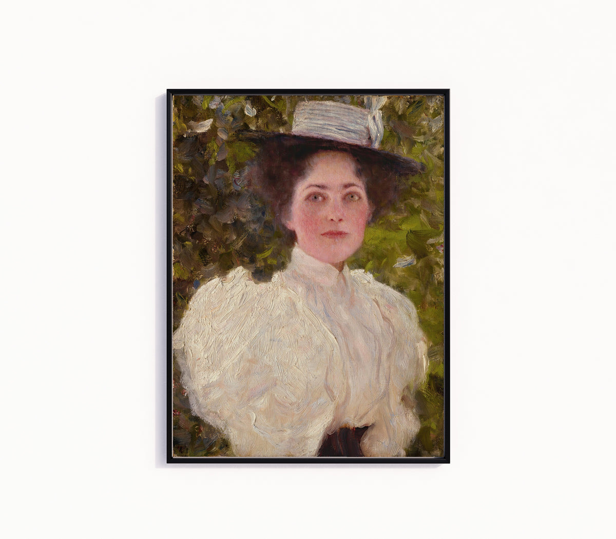 Framed art print of Girl in the Foliage (Mädchen im Grünen) by Gustav Klimt, in a slim black frame on a plain white wall