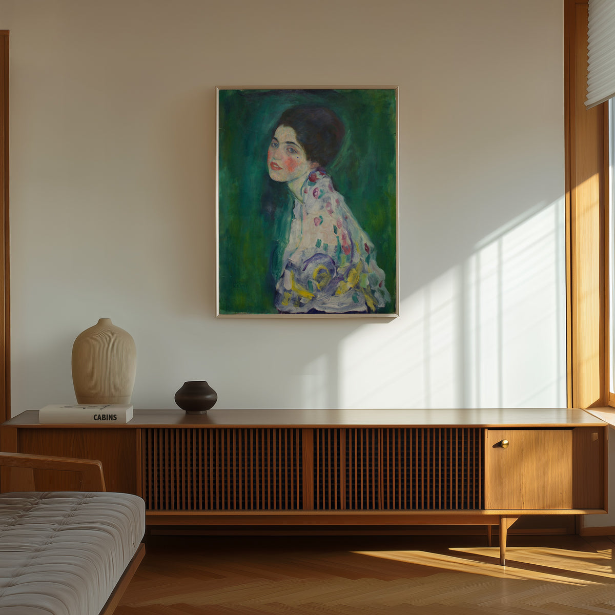 Framed art print of Portrait of a Lady by Gustav Klimt, in a thin light frame on a sunlit wall above a wooden sideboard