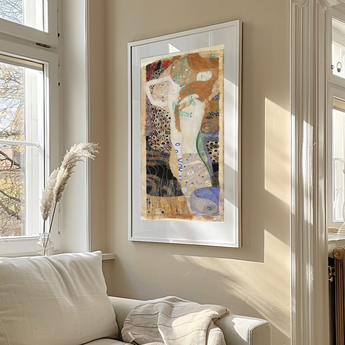 Framed art print of Water Serpents I (Friends) by Gustav Klimt, in a sunlit living room above a sofa