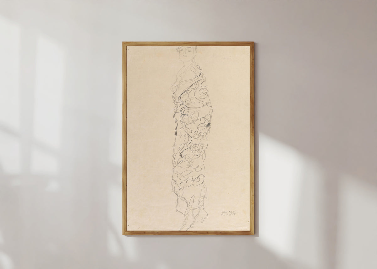 Framed art print of Woman in Kimono by Gustav Klimt, in a light wood frame on a sunlit white wall