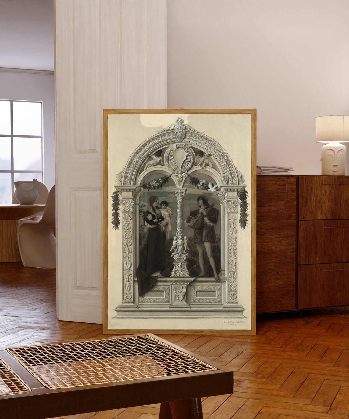 Framed art print of Youth (Die Jugend) by Gustav Klimt, in a light wood frame leaning in a warm room with a parquet floor