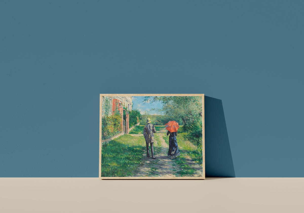 Framed art print of Couple on a Walk (Chemin montant) by Gustave Caillebotte, in a light wood frame leaning on a blue wall