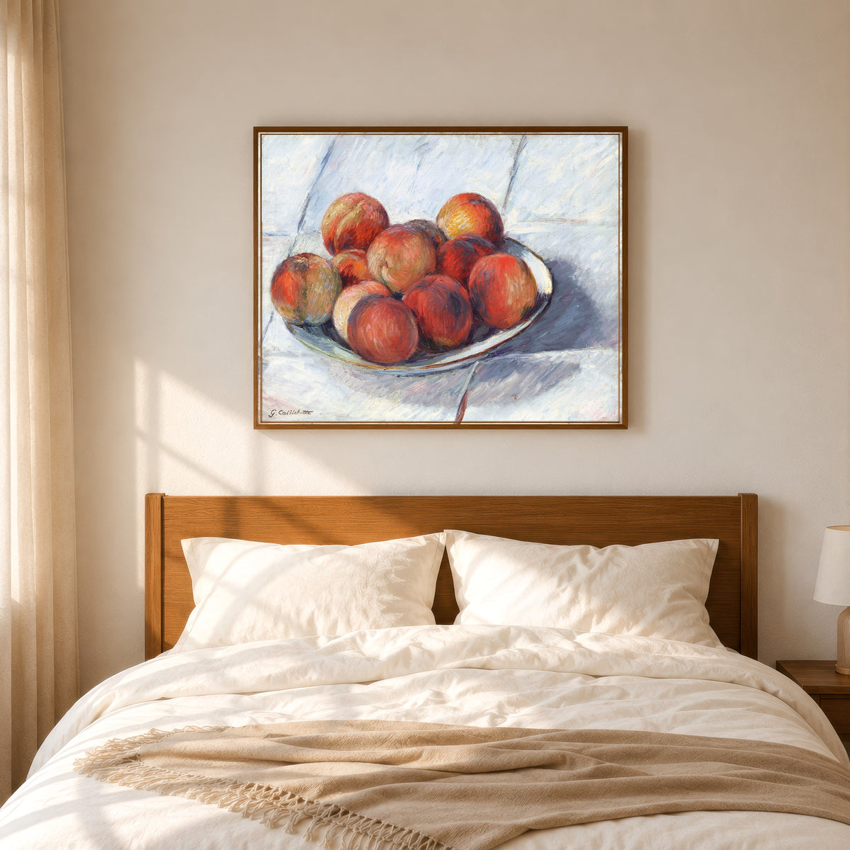 Framed art print of L’Assiette de pêches (Plate of Peaches) by Gustave Caillebotte, in a slim wood frame above a bed in a sunlit bedroom