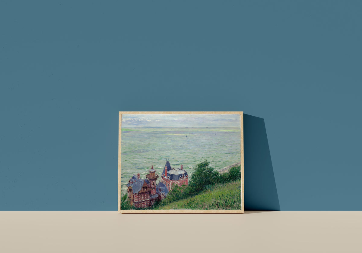 Framed art print of Villas at Trouville by Gustave Caillebotte, in a light wood frame leaning on a blue wall
