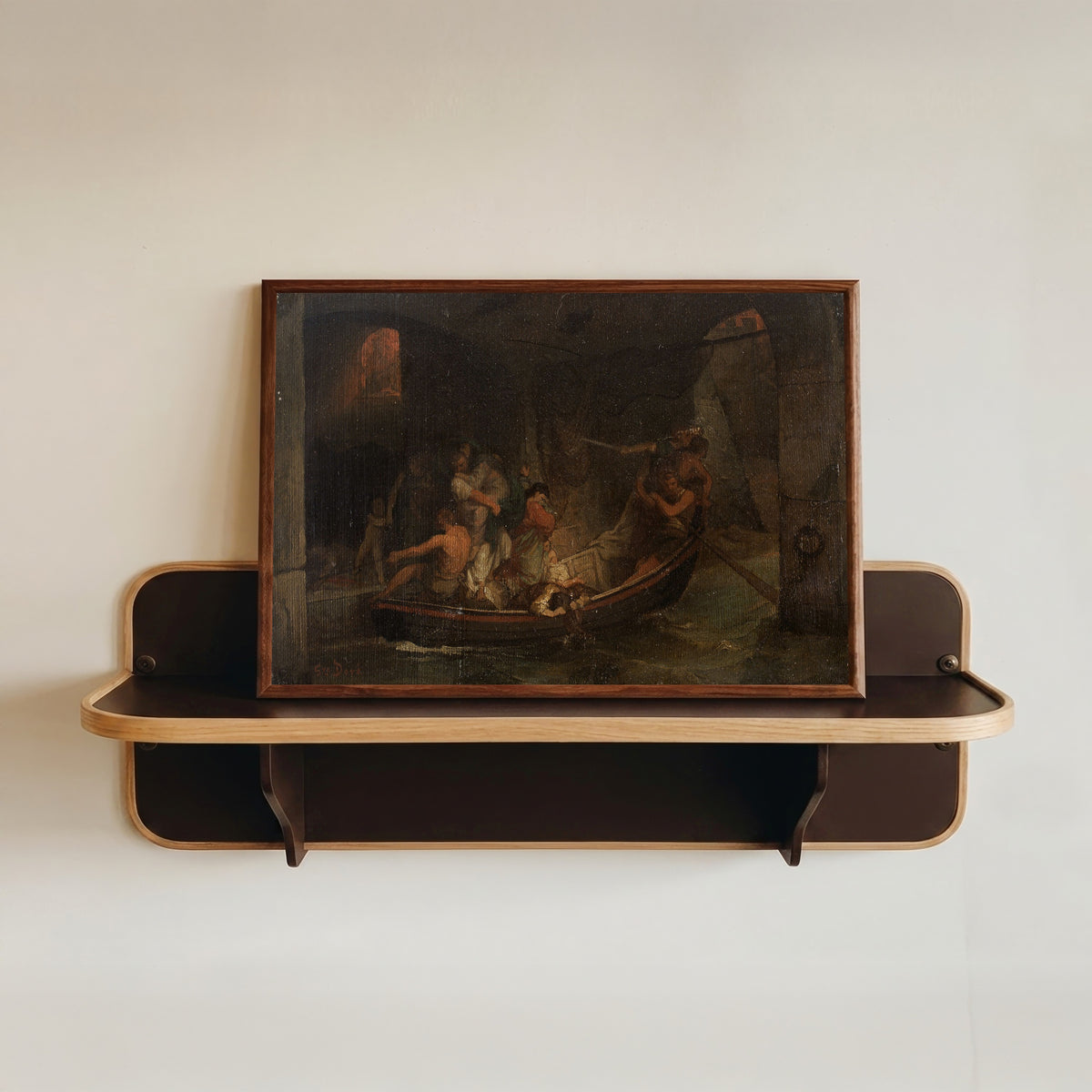 Framed art print of Rome in Flames by Gustave Doré, in a dark wood frame resting on a wall shelf
