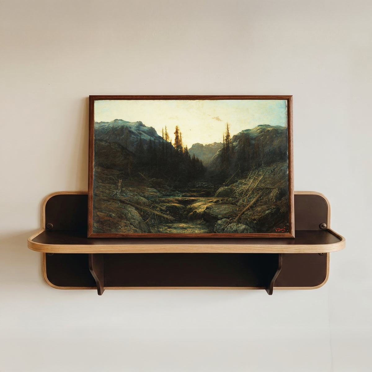 Framed art print of Stream in Mountains at Dusk by Gustave Doré, in a dark wood frame resting on a wall shelf