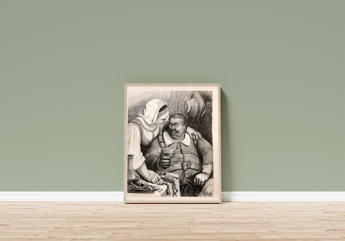 Framed art print of Tom Thumb: The Ogre at Supper by Gustave Doré, in a light wood frame leaning on a sage green wall above a wooden floor