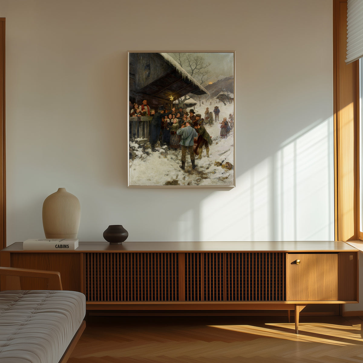 Framed art print of Weihnachtssingen im Kanton Luzern (A Christmas Carol in… by Hans Bachmann, in a thin light frame on a sunlit wall above a wooden sideboard