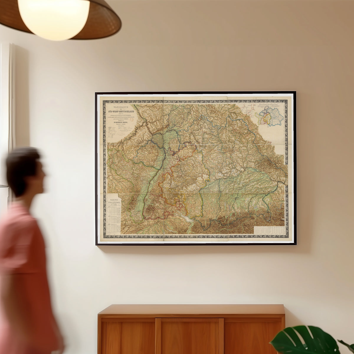 Framed art print of Wall Map of South-West Germany (Wandkarte von Süd-West-Deutschland) by Heinrich Moehl, in a slim black frame on a warm wall in a sunlit room