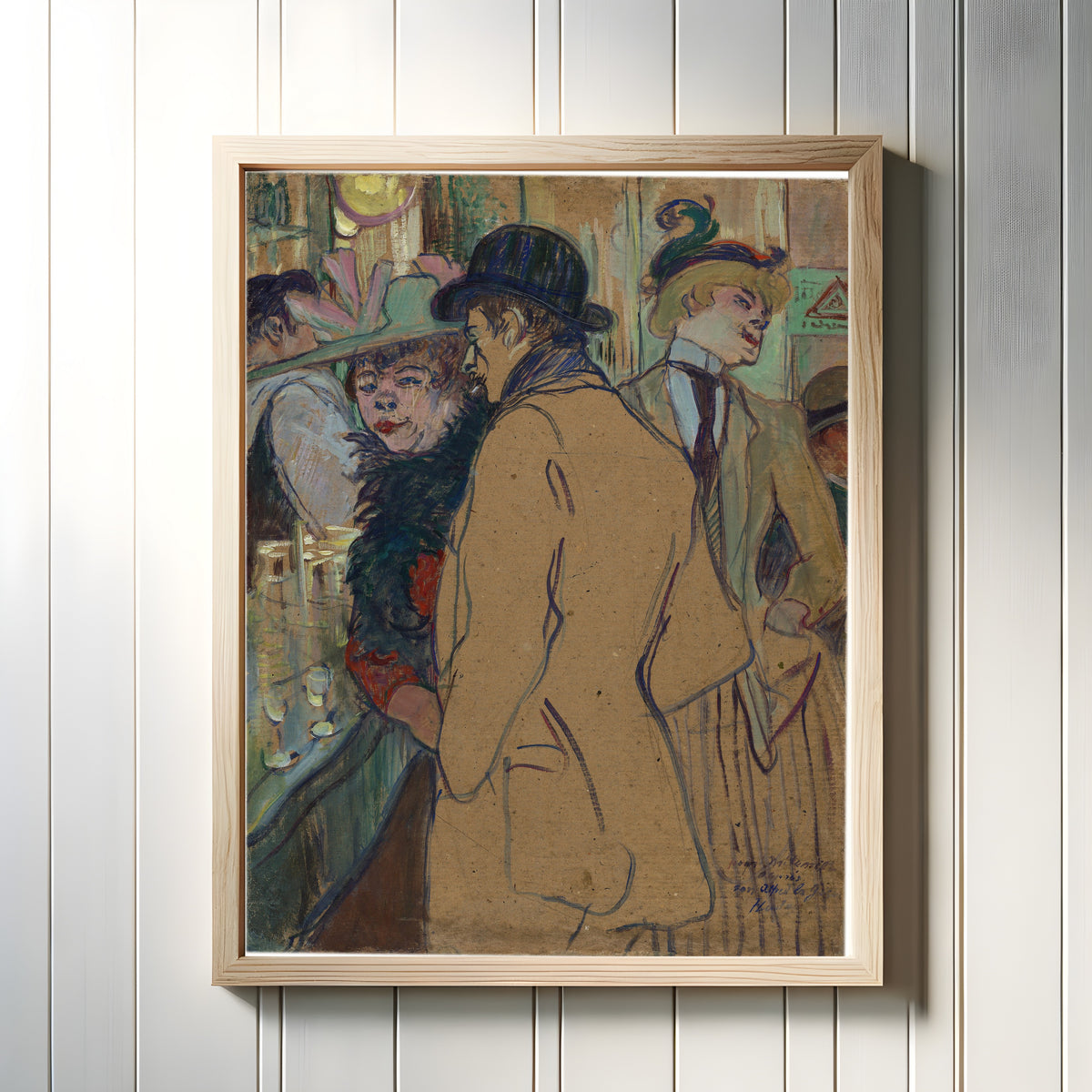 Framed art print of Alfred la Guigne by Henri de Toulouse-Lautrec, in a light wood frame on a white panelled wall