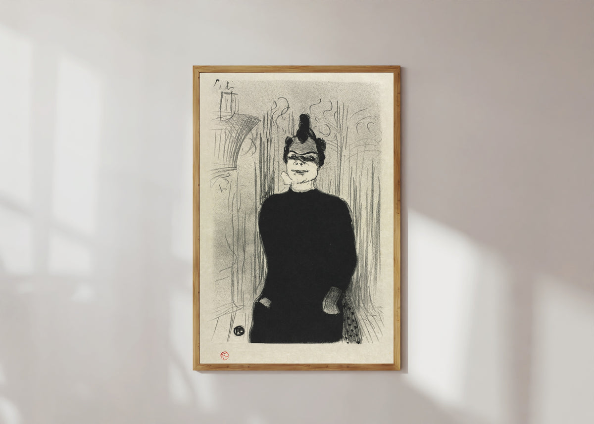 Framed art print of At the Gaieté Rochechouart: Nicolle by Henri de Toulouse-Lautrec, in a light wood frame on a sunlit white wall