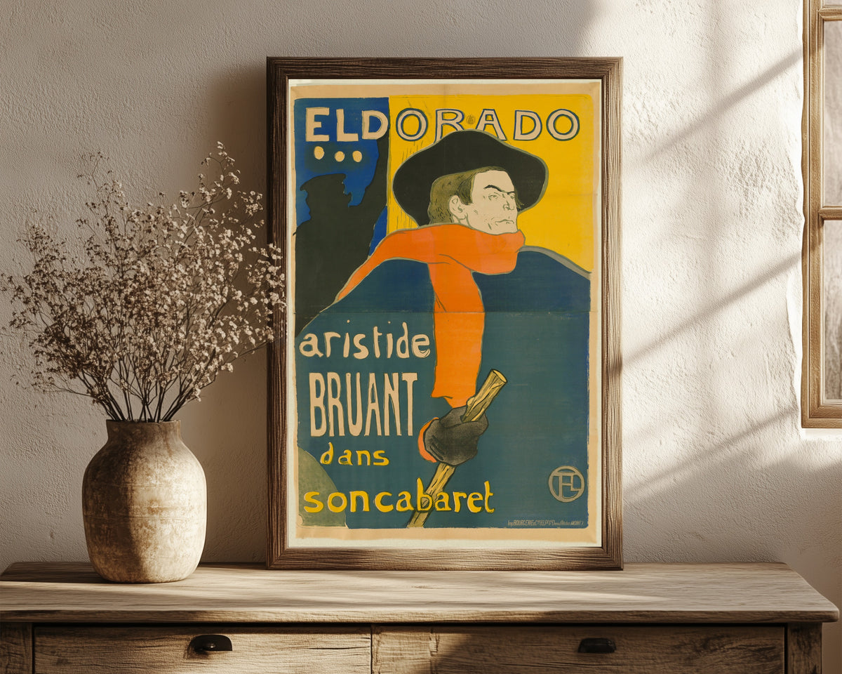 Framed art print of Eldorado: Aristide Bruant by Henri de Toulouse-Lautrec, in a dark wood frame leaning on a rustic console beside dried flowers
