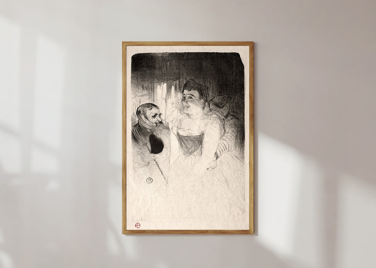 Framed art print of Judic in the Loge by Henri de Toulouse-Lautrec, in a light wood frame on a sunlit white wall