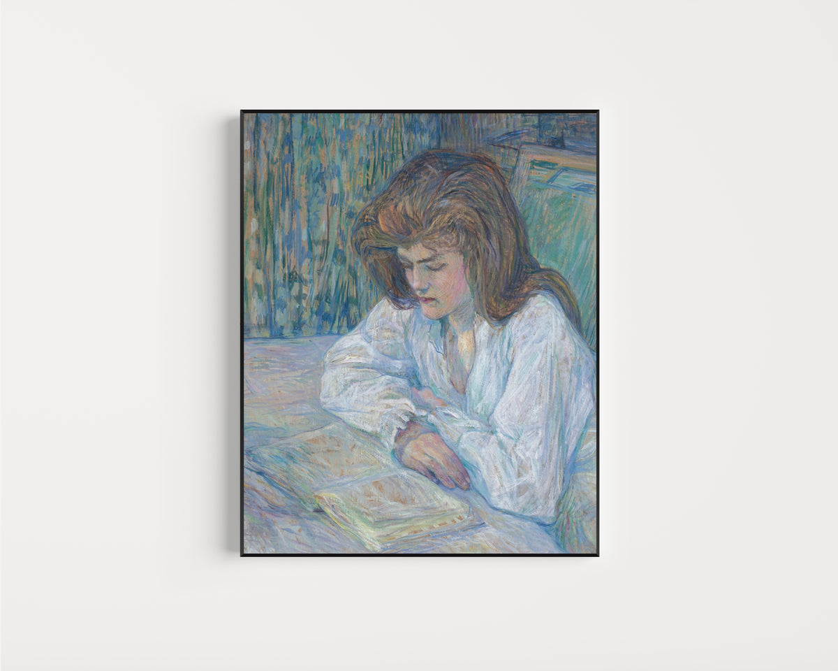 Framed art print of La Liseuse by Henri de Toulouse-Lautrec, in a slim black frame on a plain white wall