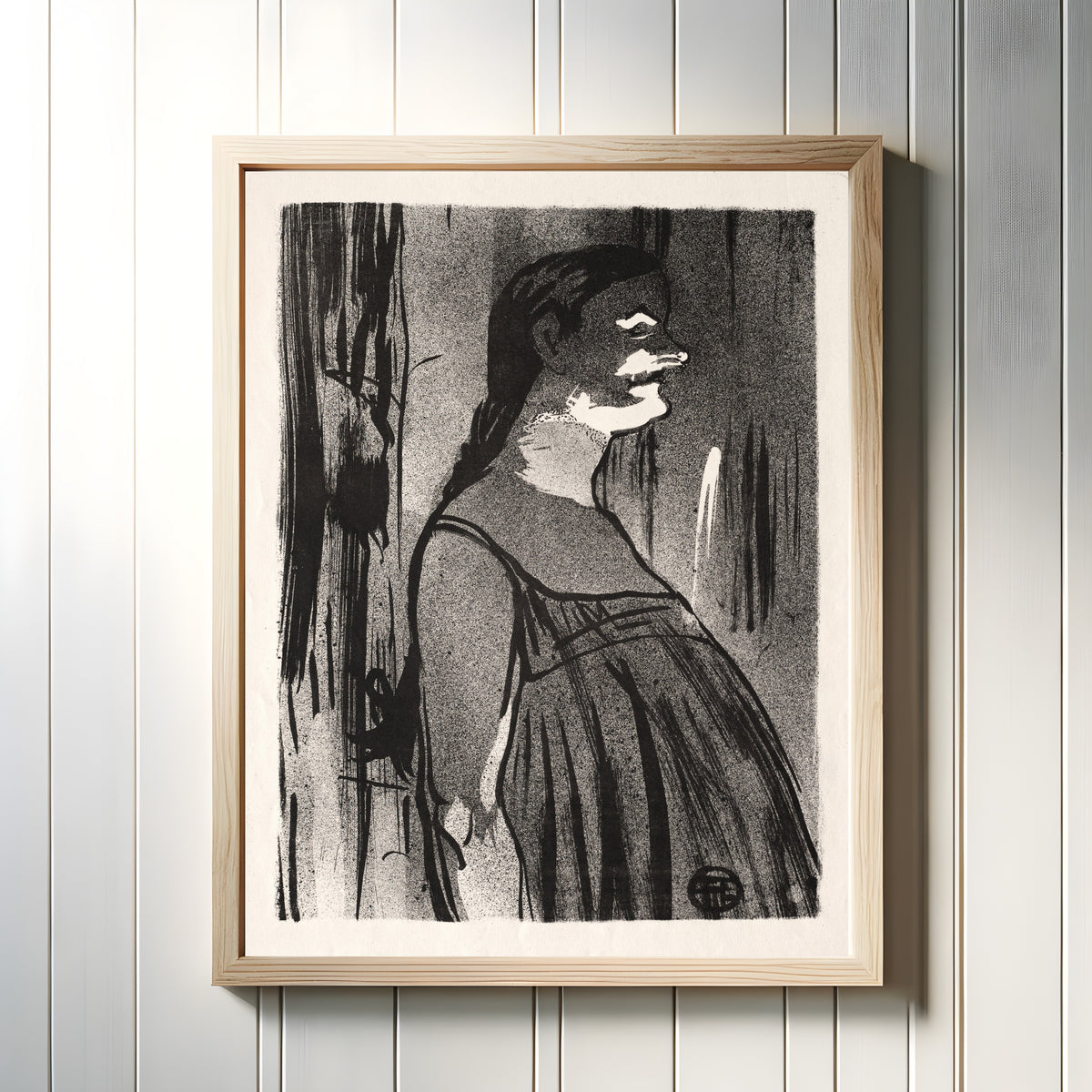 Framed art print of Le Café-Concert: Mme. Abdala by Henri de Toulouse-Lautrec, in a light wood frame on a white panelled wall