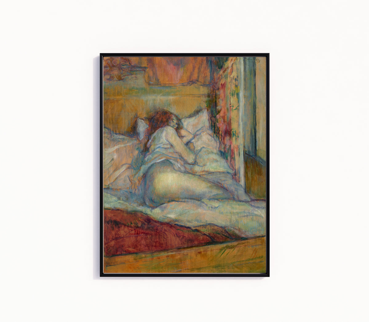 Framed art print of Le Lit (Woman Seen from Behind) by Henri de Toulouse-Lautrec, in a slim black frame on a plain white wall