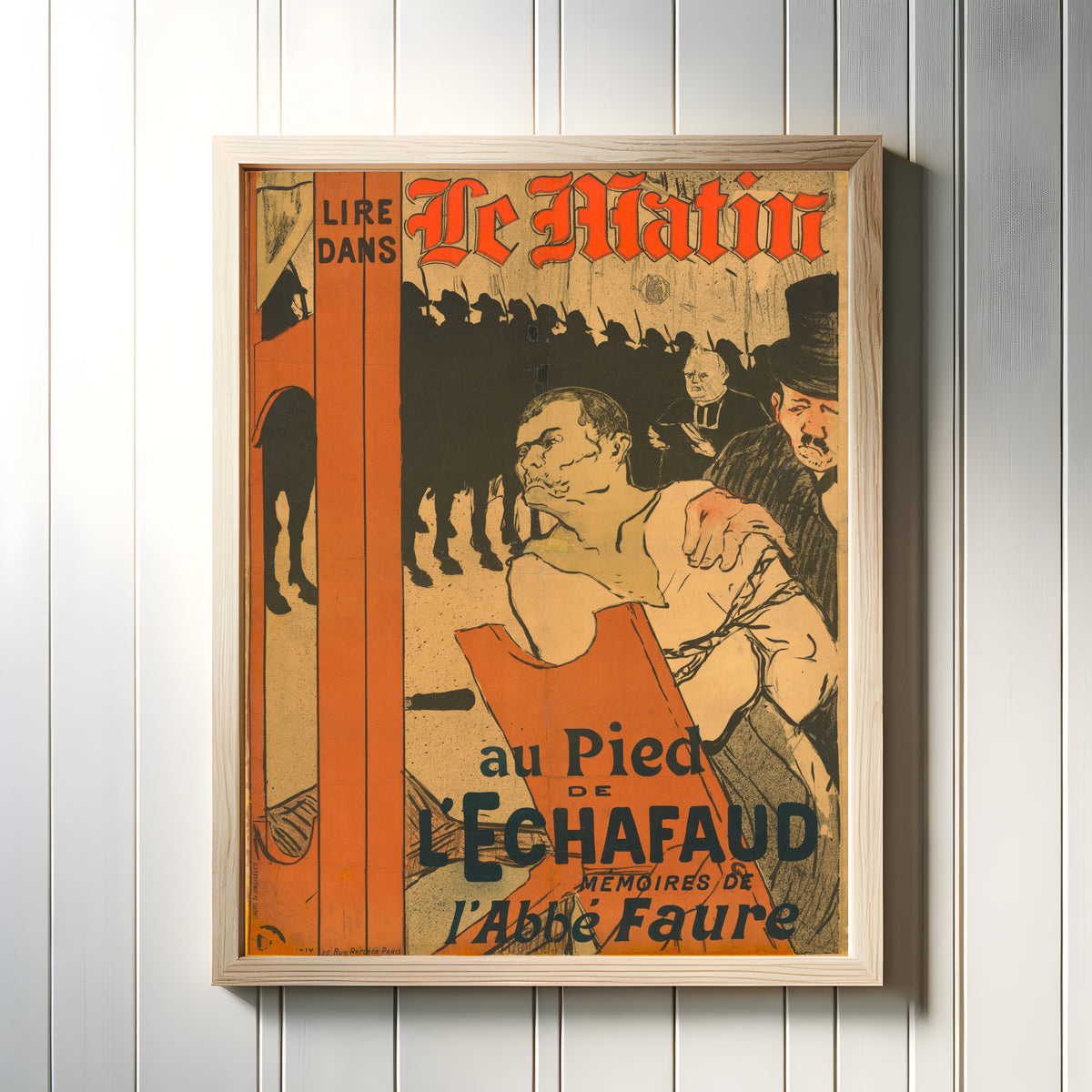 Framed art print of Le Matin: Au Pied de l'Échafaud by Henri de Toulouse-Lautrec, in a light wood frame on a white panelled wall