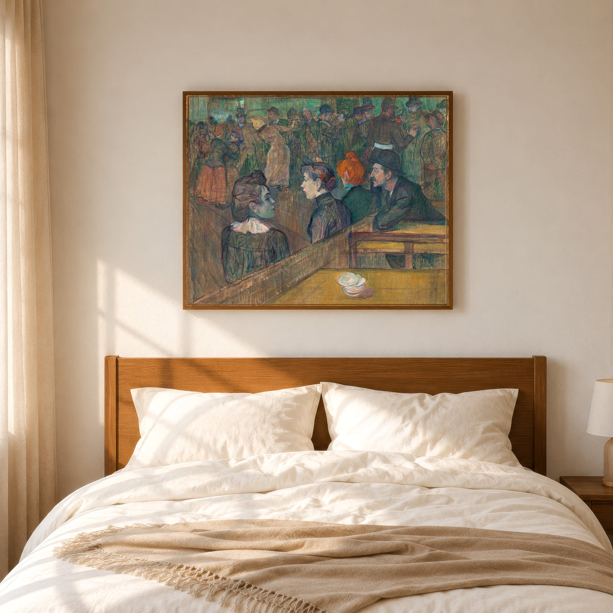 Framed art print of Moulin de la Galette by Henri de Toulouse-Lautrec, in a slim wood frame above a bed in a sunlit bedroom