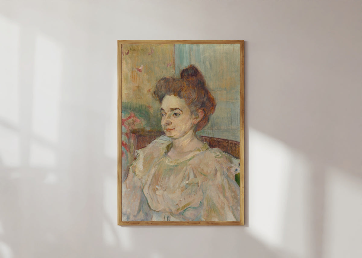 Framed art print of Portrait de Béatrice Tapié de Céleyran by Henri de Toulouse-Lautrec, in a light wood frame on a sunlit white wall