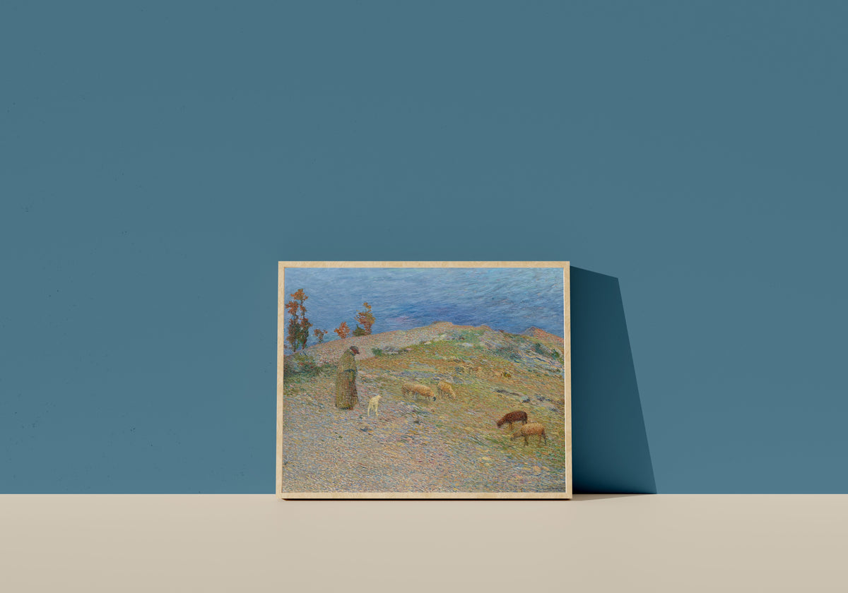 Framed art print of Berger et ses moutons dans les Causses, Lot by Henri Martin, in a light wood frame leaning on a blue wall