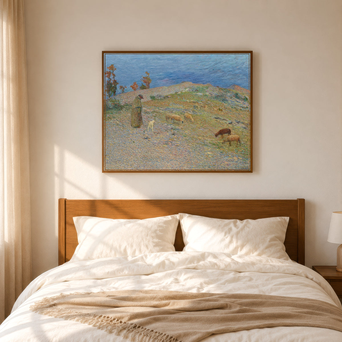 Framed art print of Berger et ses moutons dans les Causses, Lot by Henri Martin, in a slim wood frame above a bed in a sunlit bedroom