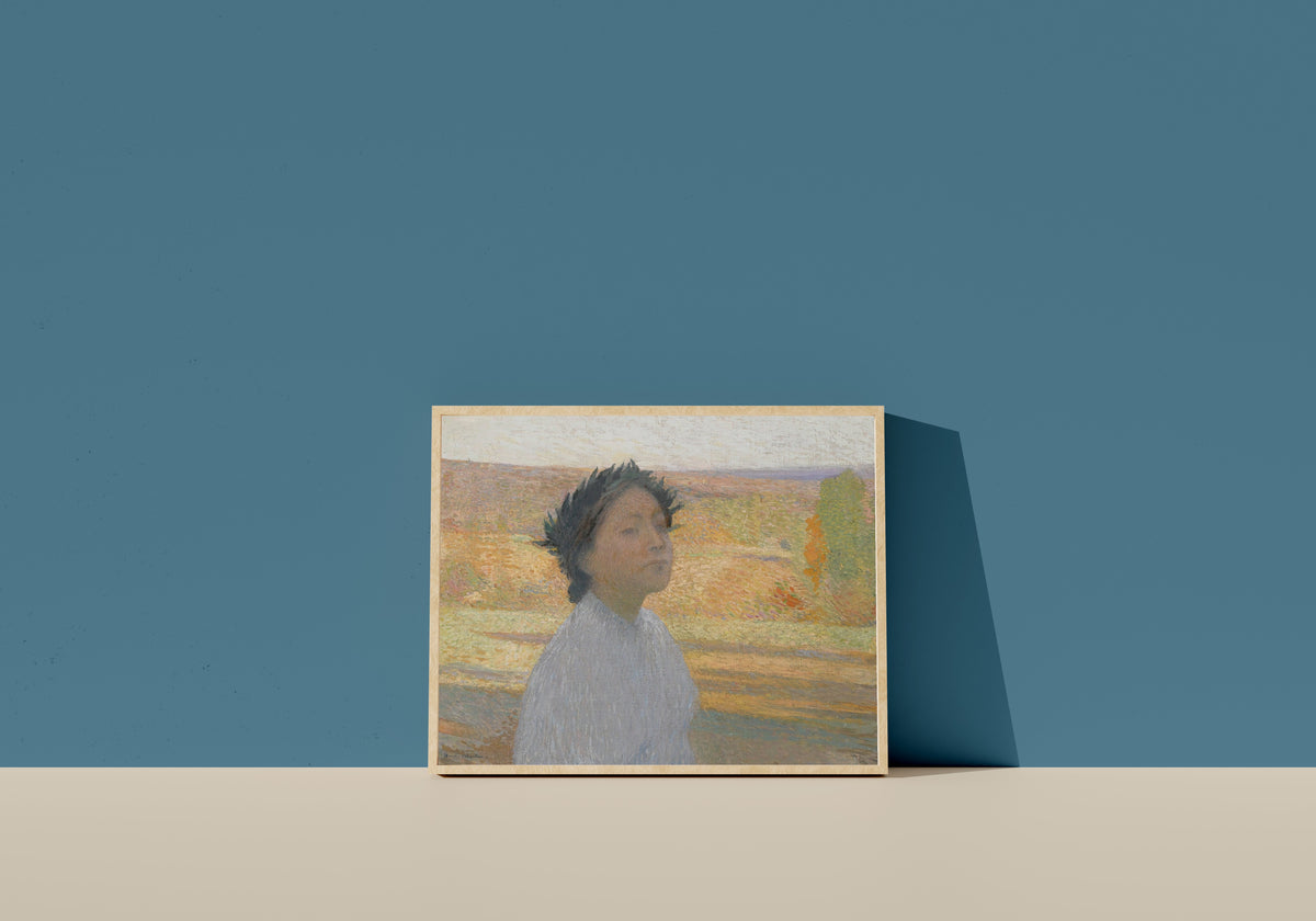Framed art print of Buste de jeune fille avec une couronne de laurier by Henri Martin, in a light wood frame leaning on a blue wall