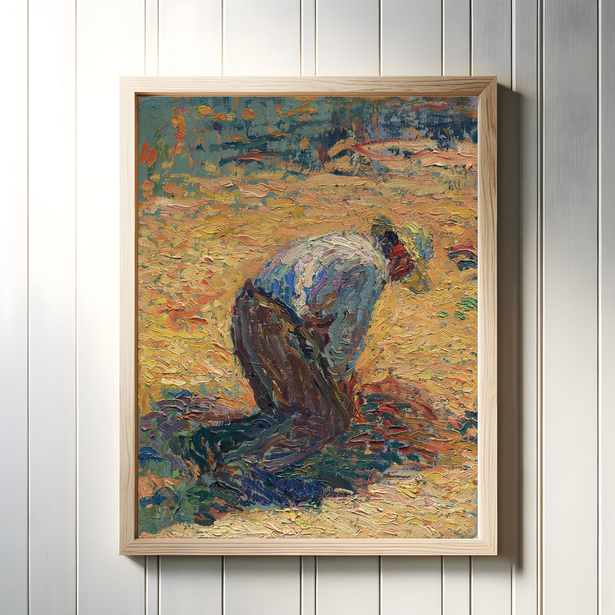 Framed art print of Étude pour La Moisson (Crouching Harvester) by Henri Martin, in a light wood frame on a white panelled wall