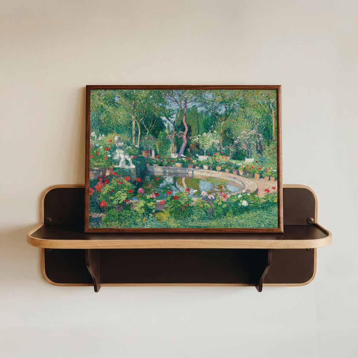 Framed art print of Grand bassin du parc de Marquayrol by Henri Martin, in a dark wood frame resting on a wall shelf