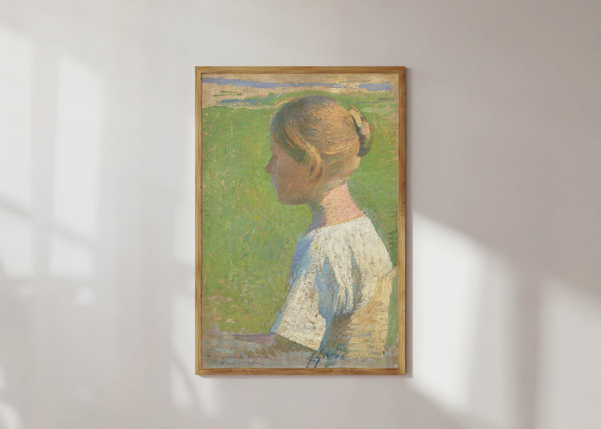 Framed art print of Jeune femme de profil by Henri Martin, in a light wood frame on a sunlit white wall