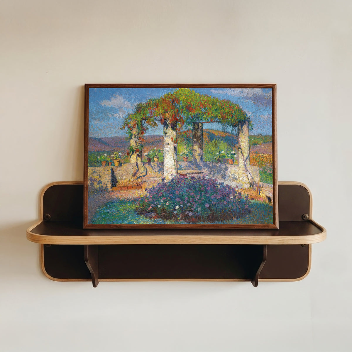 Framed art print of La Tonnelle de l'angle nord-ouest du parc de Marquayrol by Henri Martin, in a dark wood frame resting on a wall shelf