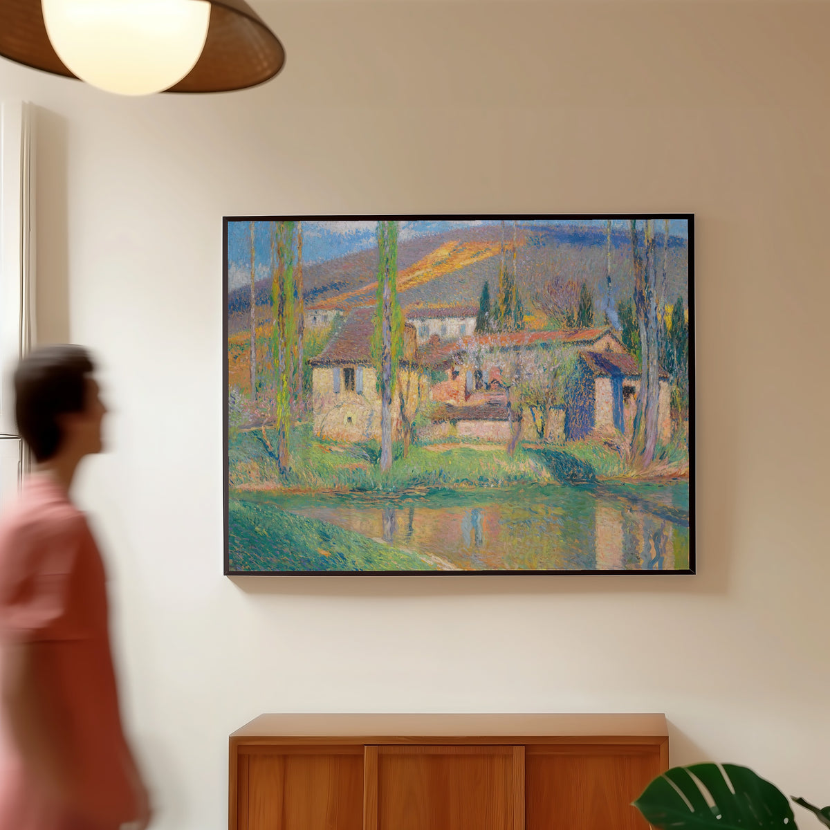Framed art print of Labastide-du-Vert (Houses Reflected in the River) by Henri Martin, in a slim black frame on a warm wall in a sunlit room