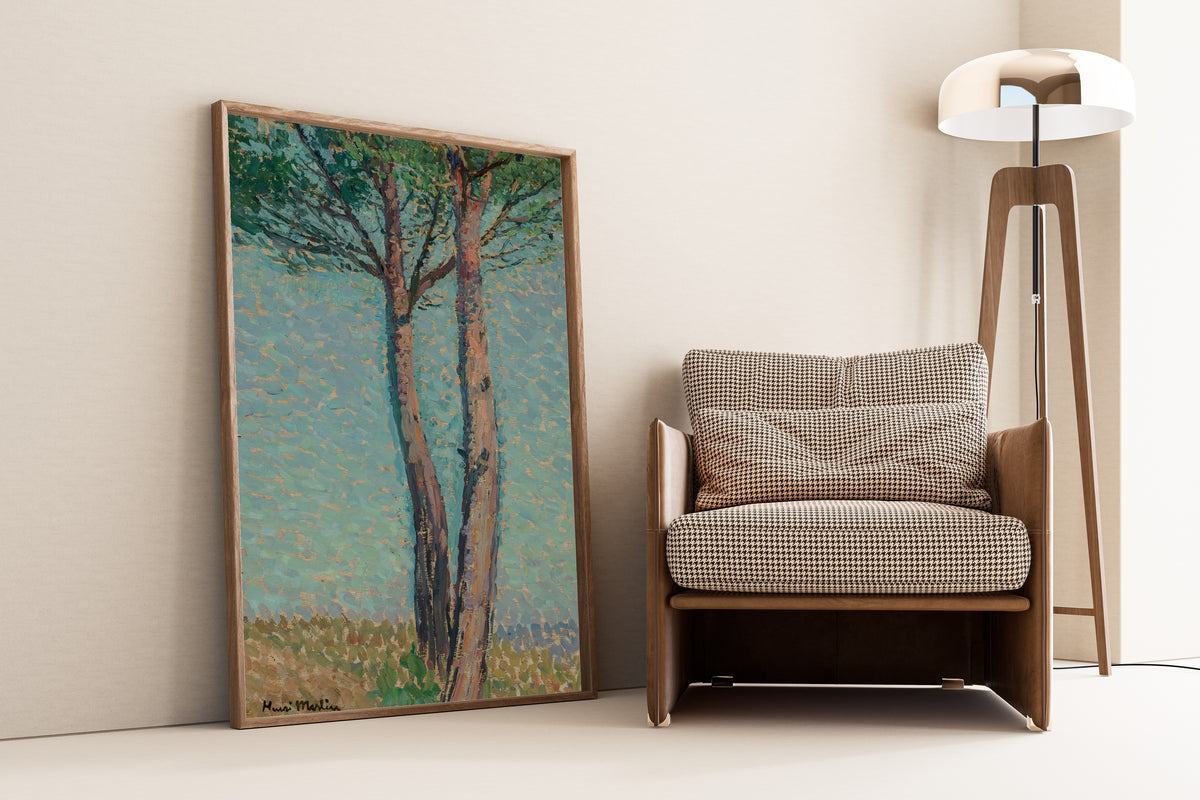 Framed art print of Un pin by Henri Martin, leaning against a wall beside an armchair and a floor lamp
