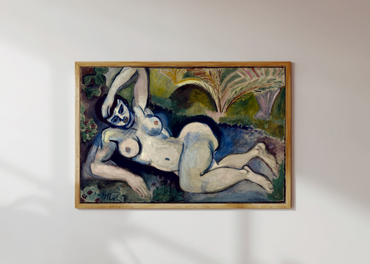 Framed art print of Blue Nude (Souvenir de Biskra) by Henri Matisse, in a light wood frame on a sunlit white wall